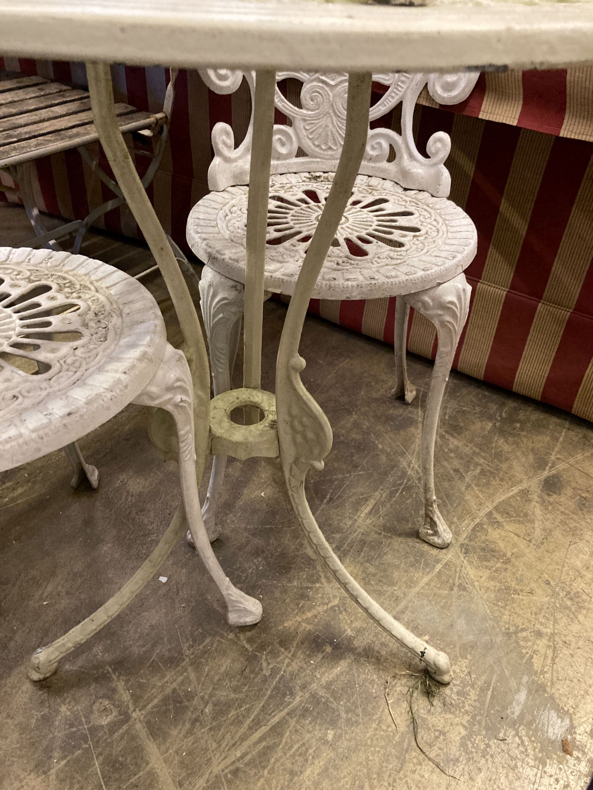 A circular Victorian style painted aluminium garden table, diameter 69cm together with a set of four similar chairs